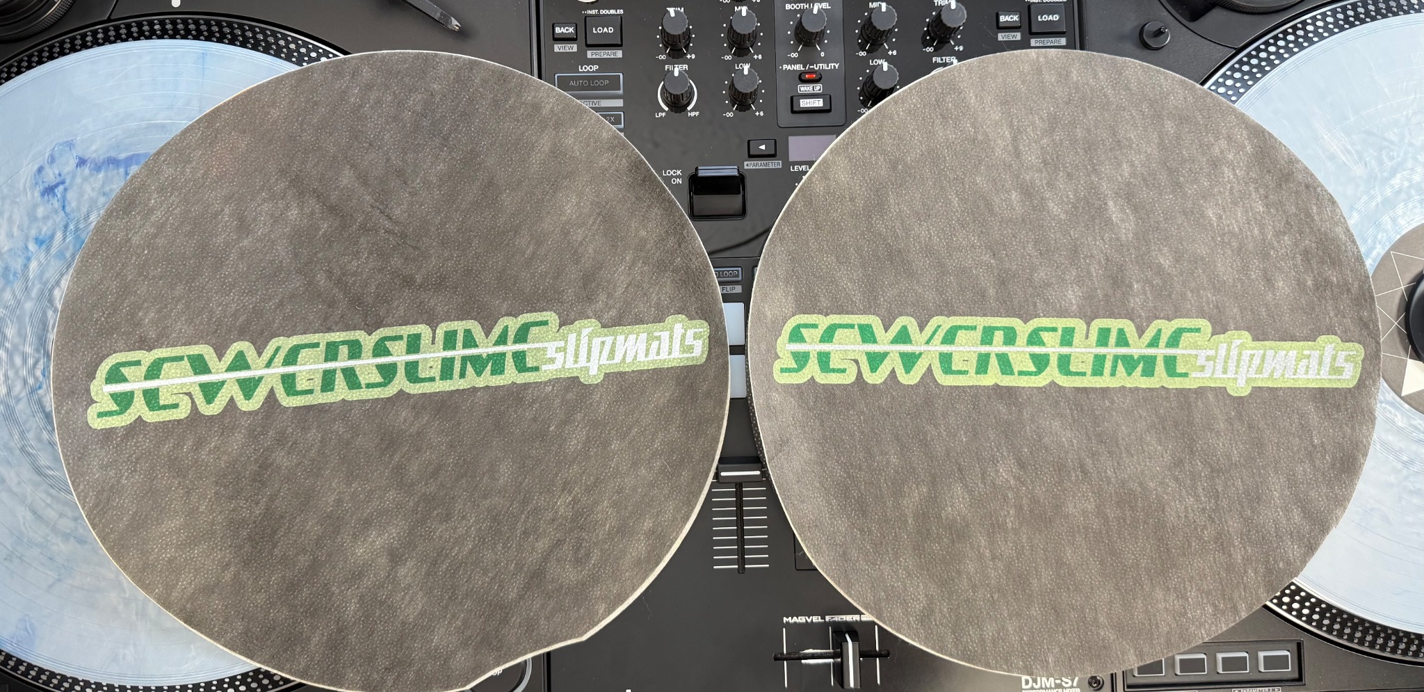 Two original Sewer Slime prototype slipmats photographed together in 2026